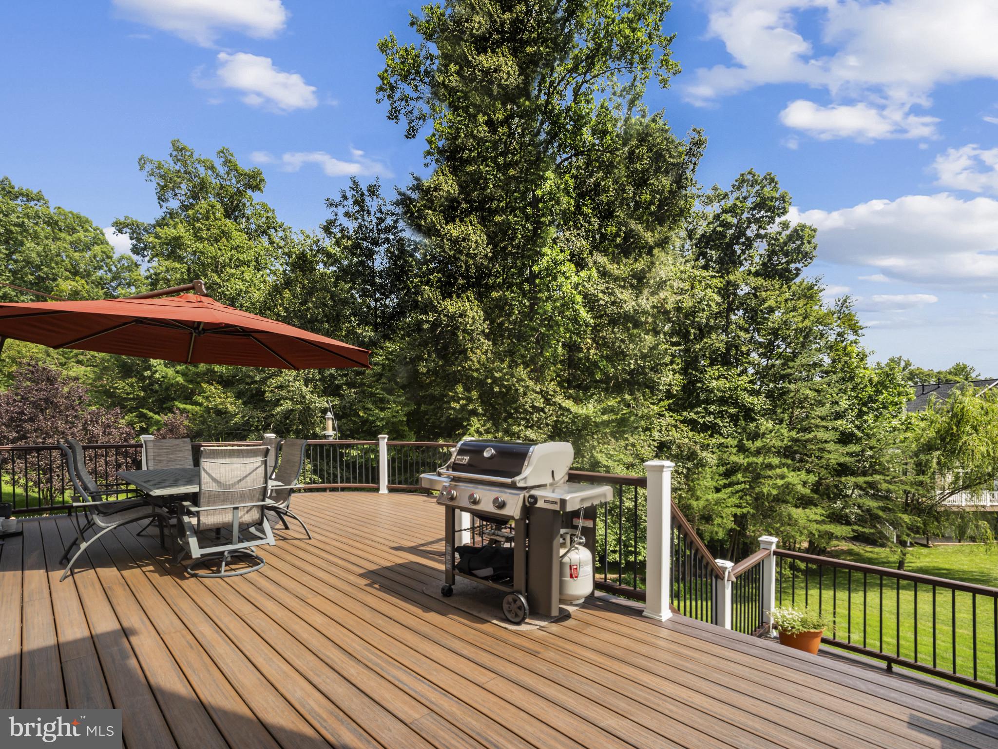 733 Seneca Drive Odenton, MD 21113 - Photo 25 of 83 a view of a roof deck with table and chairs a barbeque with wooden floor and fence