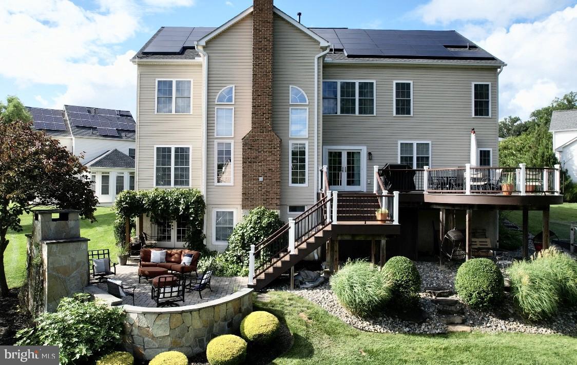 733 Seneca Drive Odenton, MD 21113 - Photo 67 of 83 a view of a patio with table and chairs potted plants and a large tree