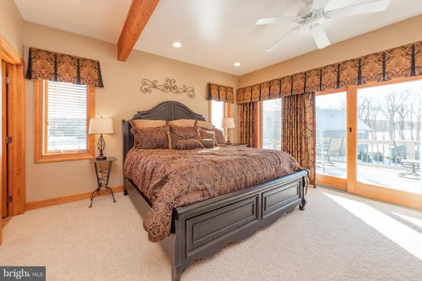 a bedroom with a large bed and a large window