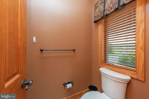 a view of a bedroom with a bed and wooden floor