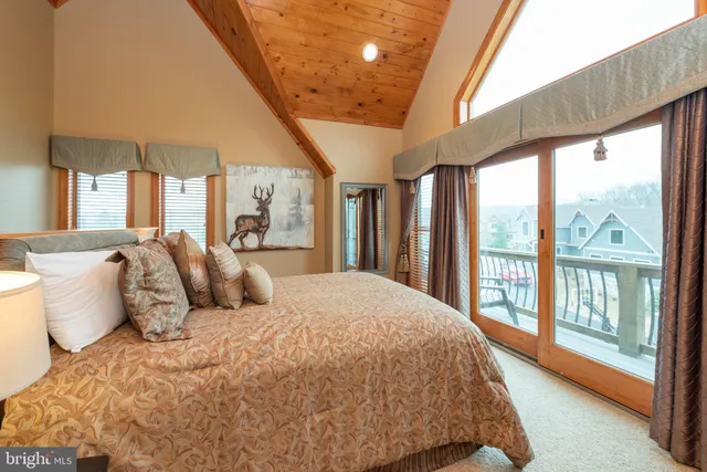 a living room with furniture a window and a chandelier
