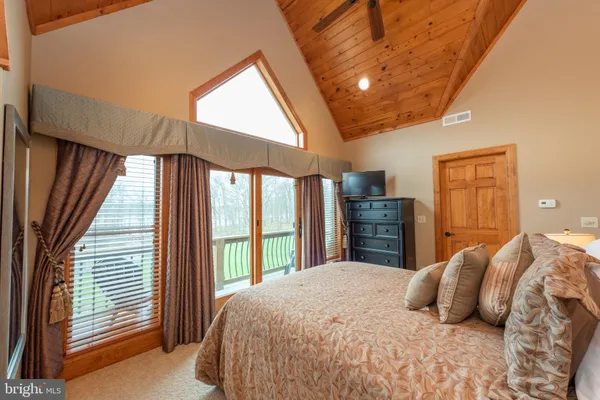 a room with pool table and windows
