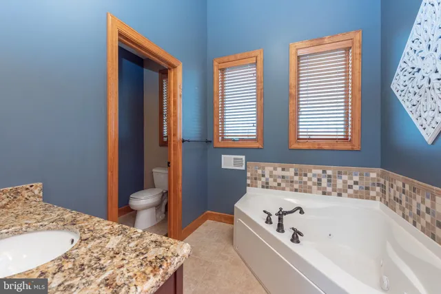 a room with furniture pool table and flat screen tv