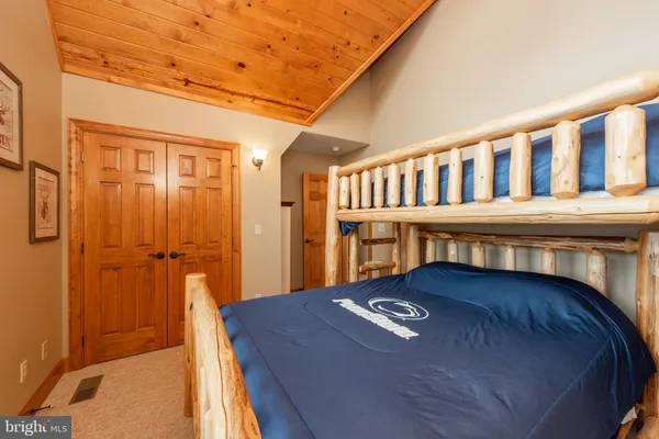 a bedroom with a bed dresser and a window