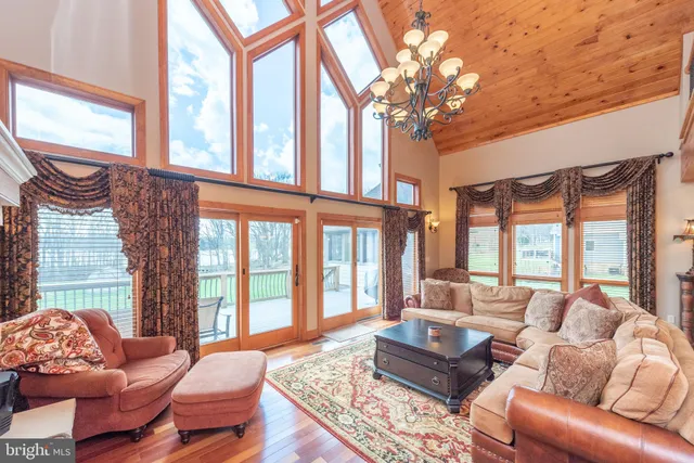 a kitchen with stainless steel appliances granite countertop table chairs and a refrigerator