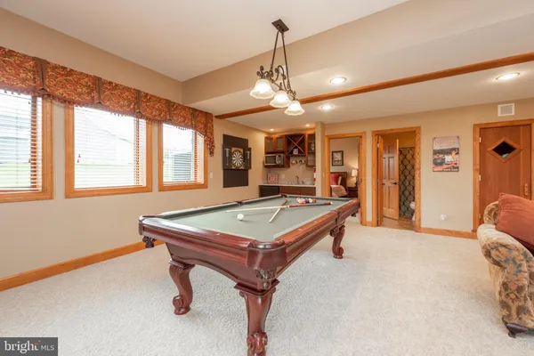 a view of patio with table and chairs and potted plants
