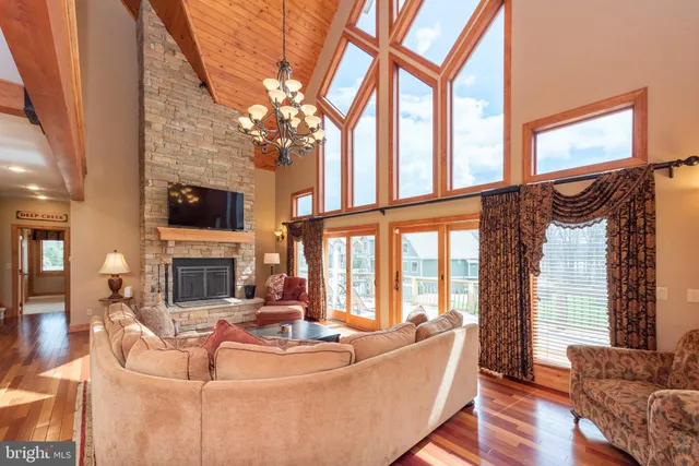 a view of a dining room with furniture wooden floor and chandelier
