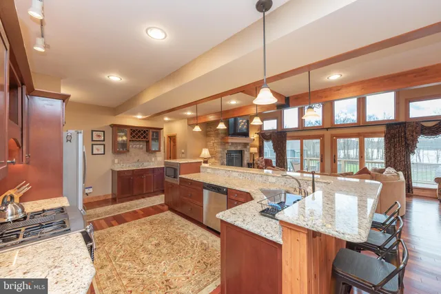a bathroom with a granite countertop sink and a toilet