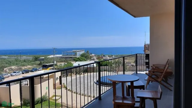 a view of a chairs and table in the balcony