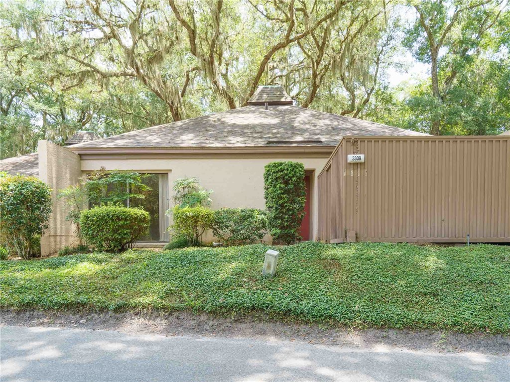 3309 Sea Marsh Road, Unit 3309 Fernandina Beach, FL 32034 - Photo 1 of 34 a view of a house with a yard and plants