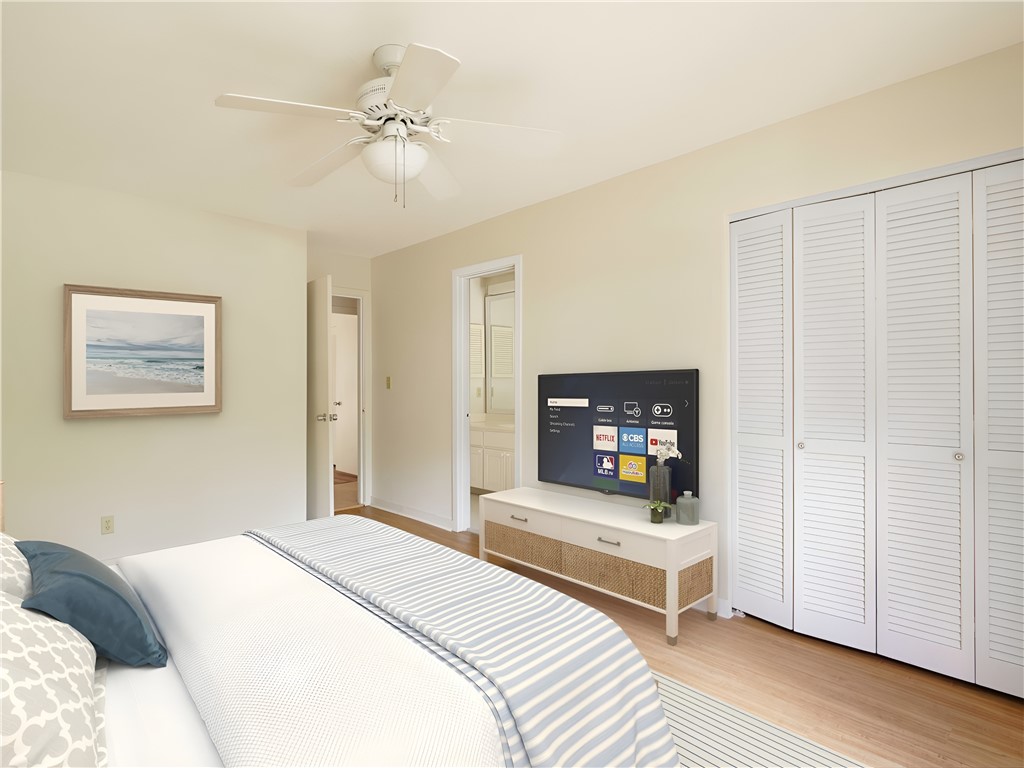 3309 Sea Marsh Road, Unit 3309 Fernandina Beach, FL 32034 - Photo 11 of 34 a bedroom with a bed and a chandelier