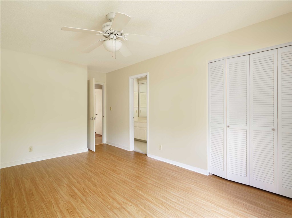 3309 Sea Marsh Road, Unit 3309 Fernandina Beach, FL 32034 - Photo 12 of 34 an empty room with wooden floor and fan