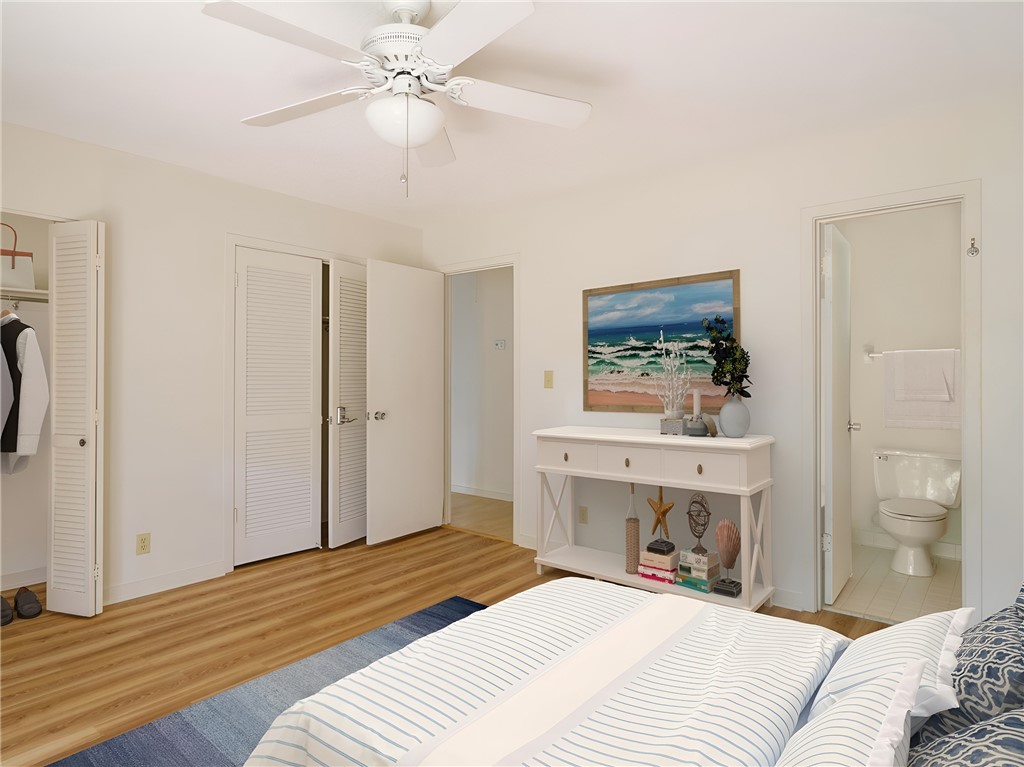 3309 Sea Marsh Road, Unit 3309 Fernandina Beach, FL 32034 - Photo 15 of 34 a bedroom with a bed and a chandelier
