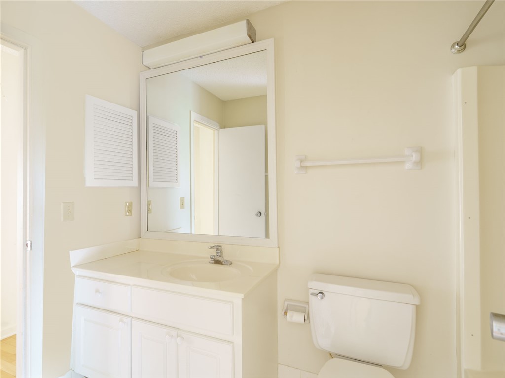 3309 Sea Marsh Road, Unit 3309 Fernandina Beach, FL 32034 - Photo 25 of 34 a bathroom with a sink a toilet and a mirror