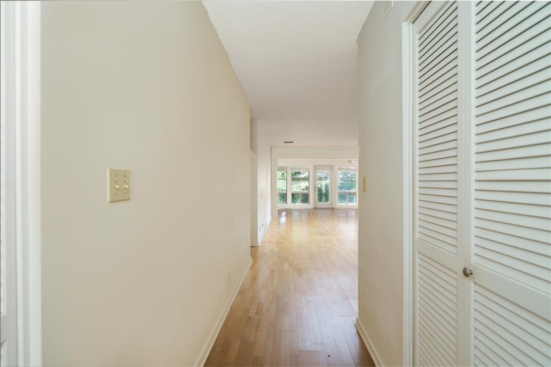 3309 Sea Marsh Road, Unit 3309 Fernandina Beach, FL 32034 - Photo 28 of 34 a view of a hallway with wooden floor and a bathroom