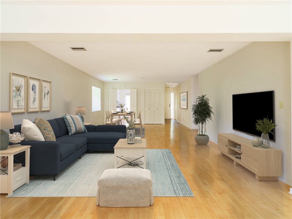 3309 Sea Marsh Road, Unit 3309 Fernandina Beach, FL 32034 - Photo 3 of 34 a living room with furniture and a flat screen tv