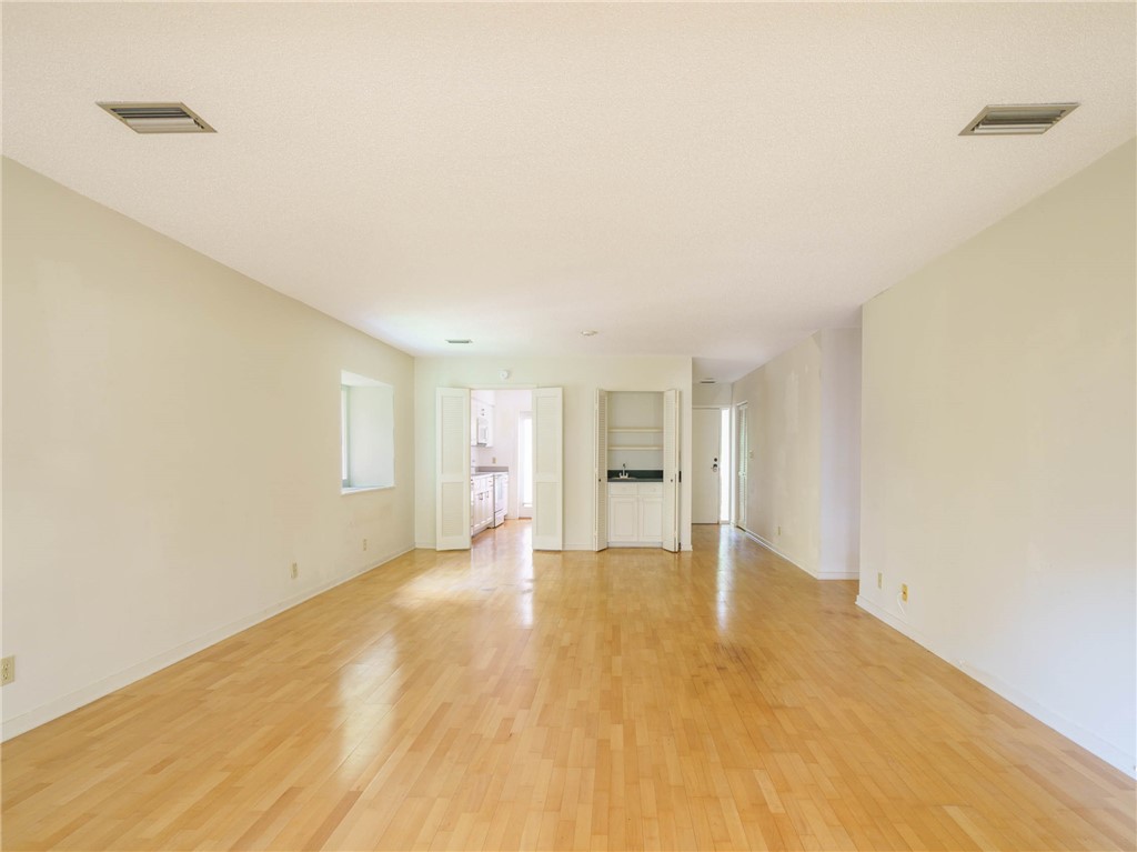 3309 Sea Marsh Road, Unit 3309 Fernandina Beach, FL 32034 - Photo 4 of 34 a view of empty room with wooden floor and fan