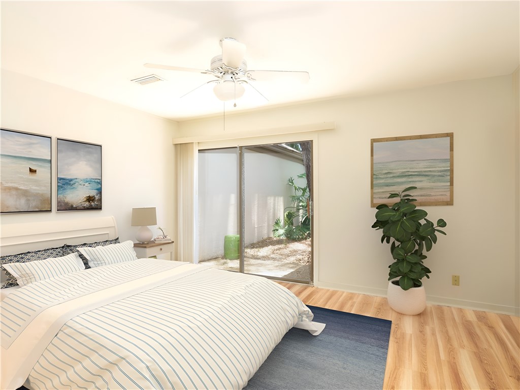 3309 Sea Marsh Road, Unit 3309 Fernandina Beach, FL 32034 - Photo 7 of 34 a bedroom with a large bed and a chandelier