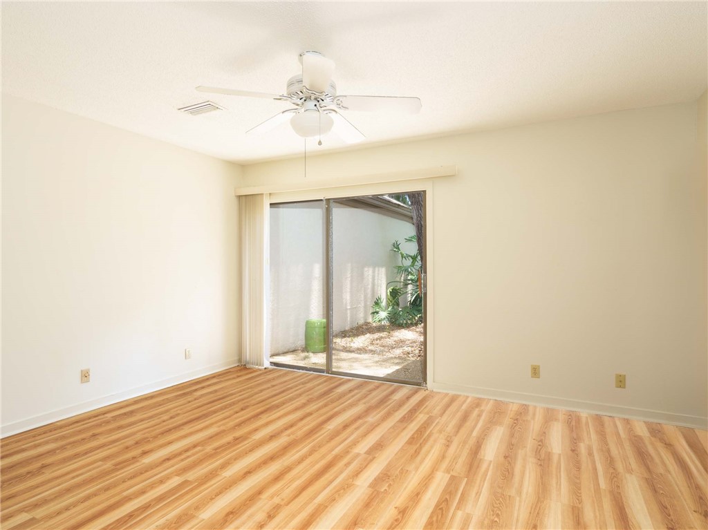 3309 Sea Marsh Road, Unit 3309 Fernandina Beach, FL 32034 - Photo 8 of 34 a view of a room with wooden floor and fan