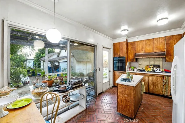 a living room with fireplace furniture and a large window