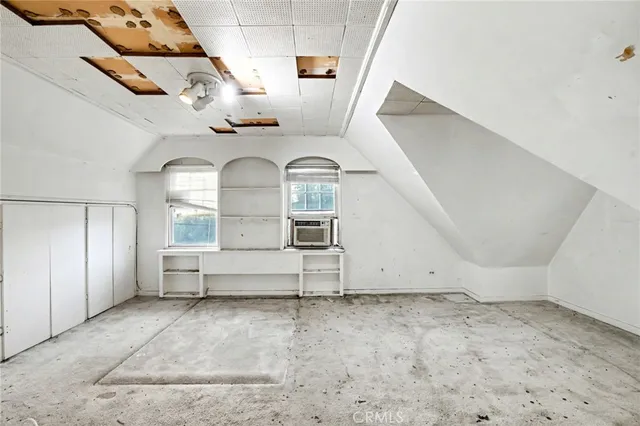 a spacious bedroom with a bed and a large window