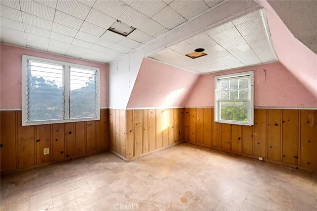a room with lots of potted plants and large trees