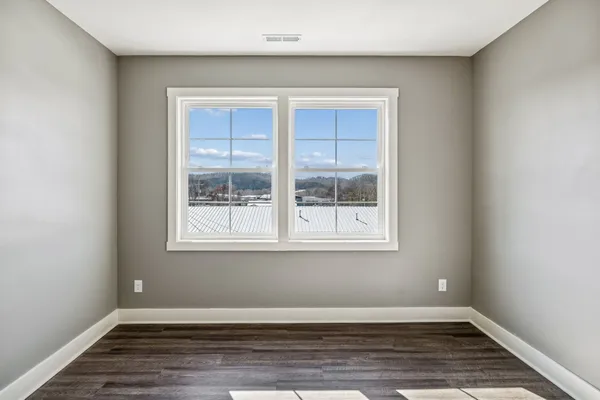 a view of wooden floor and window in a room