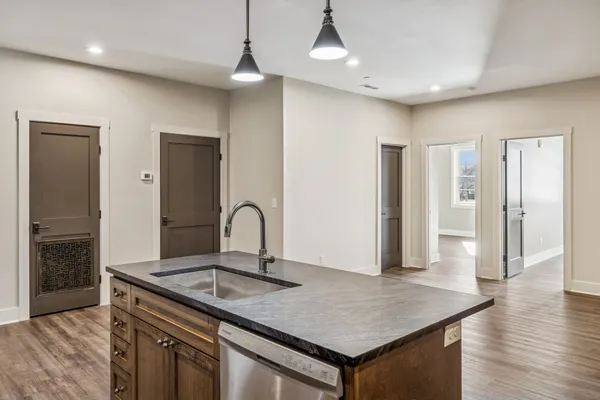 a kitchen with a sink a refrigerator and cabinets
