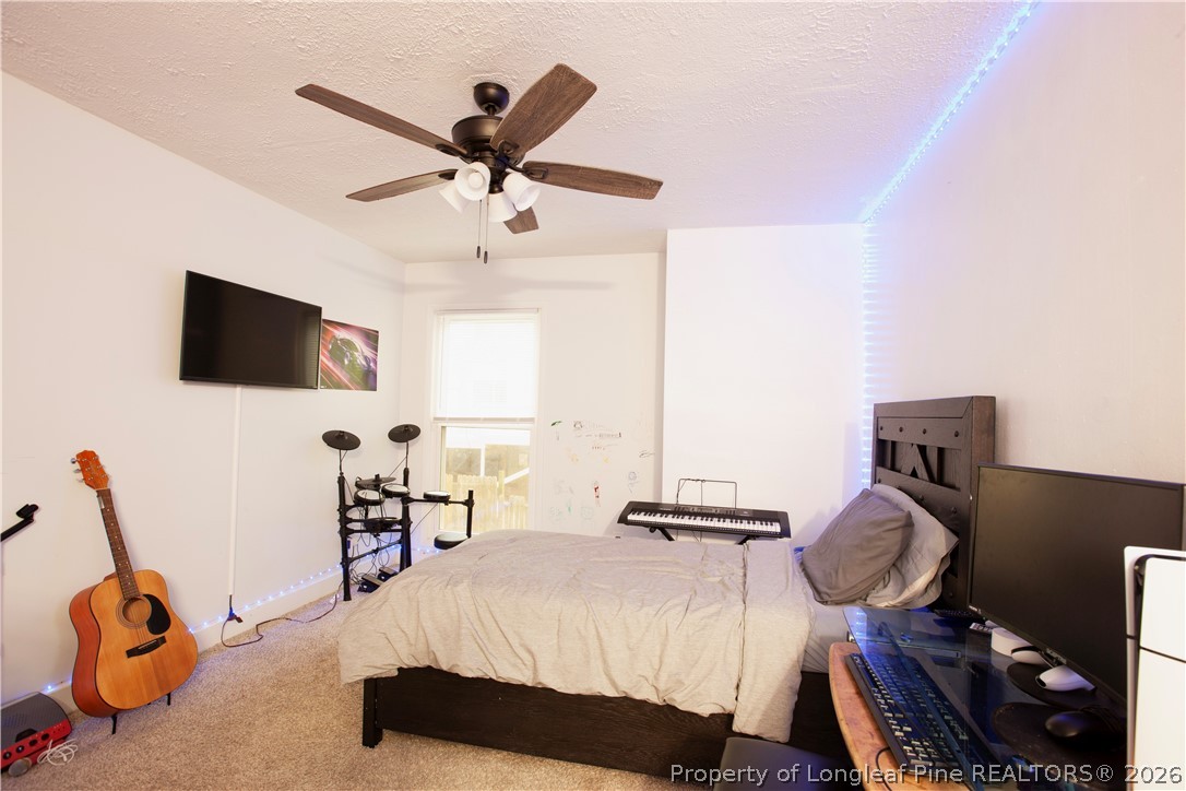 5948 Dalton Road Fayetteville, NC 28314 - Photo 15 of 18 a bedroom with a bed and tv