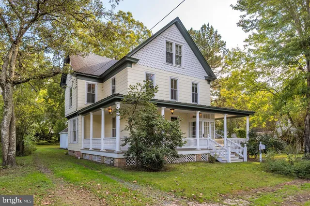 a front view of a house with a garden and yard