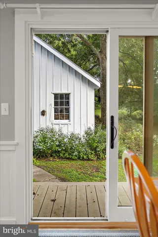 a view of a house with a balcony and wooden fence