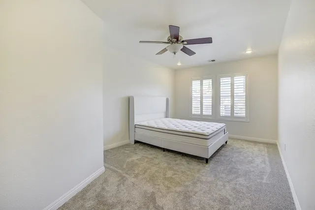 a living room with a bed furniture and a window