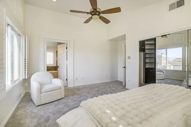 a bedroom with a bed and ceiling fan