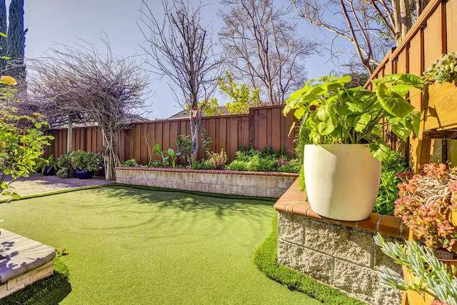 a view of swimming pool with a patio and garden