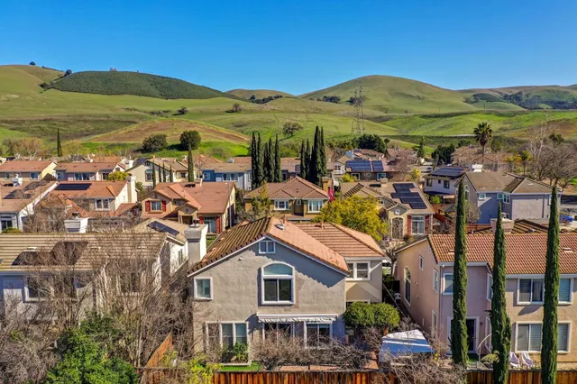 a view of a large building with a mountain in the background
