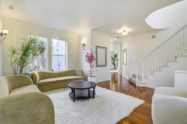 a living room with furniture and a potted plant