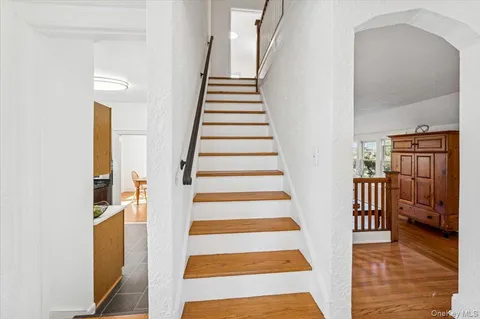 a view of entryway and hall with wooden floor