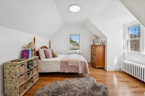 a room with a bed and wooden floor