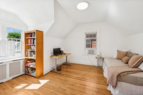 a bedroom with furniture and a window