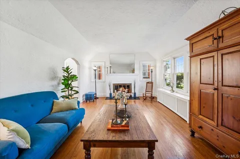 a living room with furniture fireplace and a table
