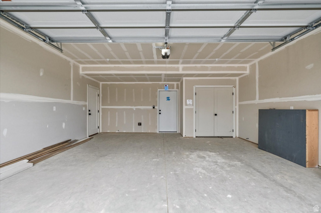 844 North 400 West Logan, UT 84321 - Photo 33 of 43 Spacious garage featuring a concrete floor, two entry doors, and a double-door closet