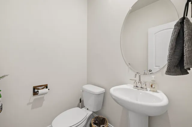 a bathroom with a sink a mirror and a toilet