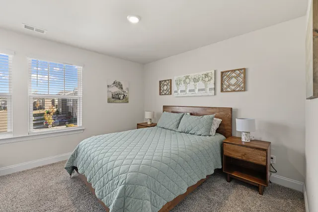 a bedroom with a bed and a couch