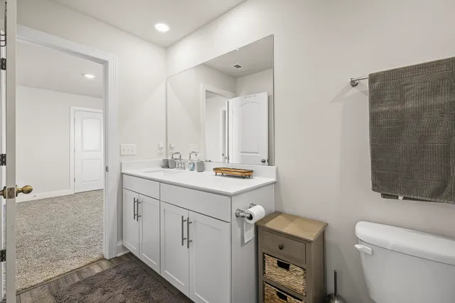 a bathroom with a sink toilet double vanity and shower