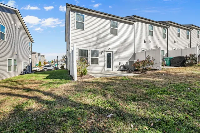 a backyard of a house with table and chairs