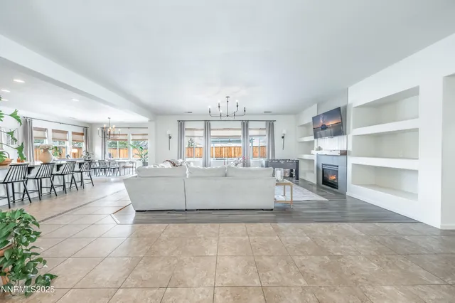 a living room with furniture and a dining table with kitchen view