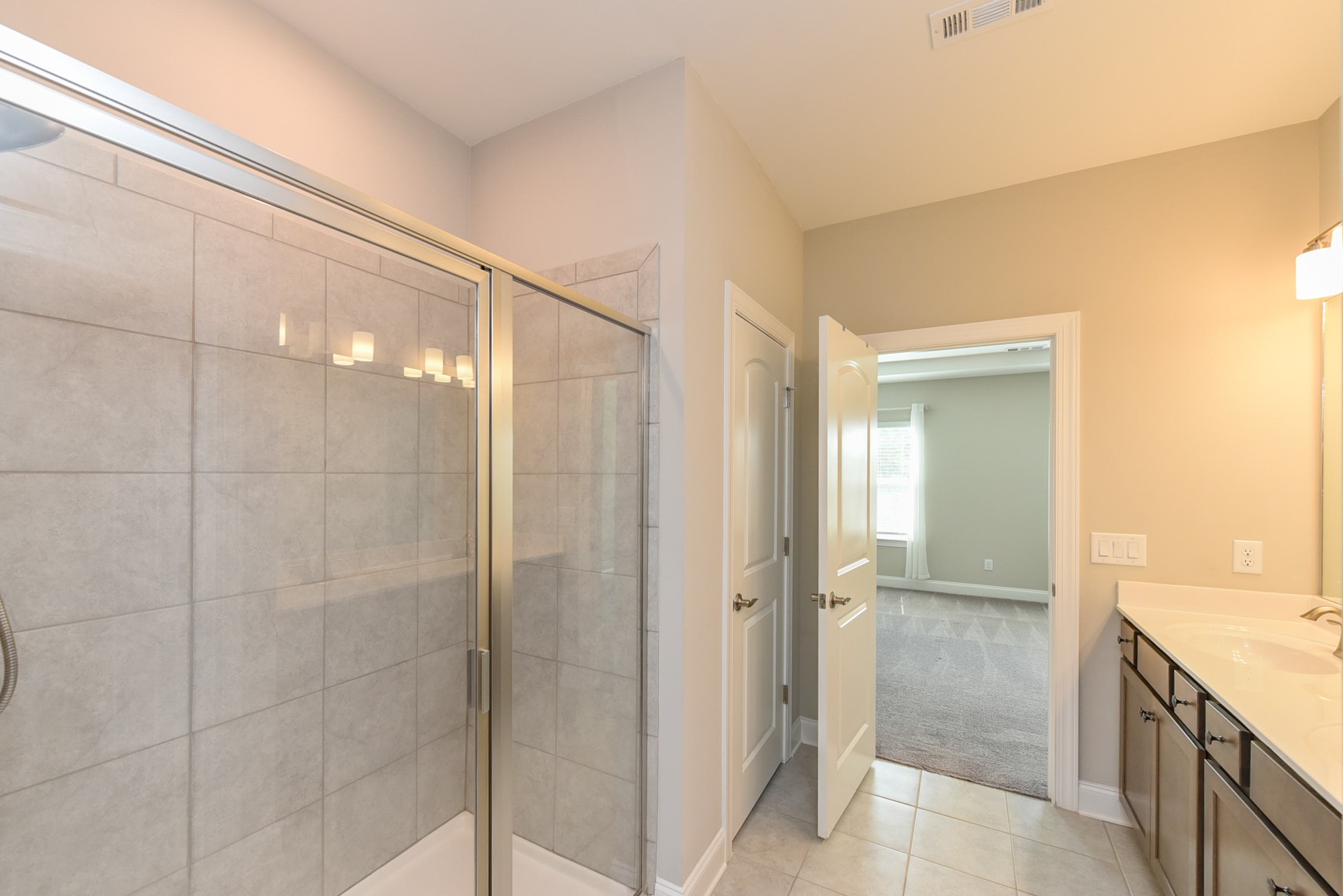 551 Fall Creek Circle Goodlettsville, TN 37072 - Photo 12 of 28 a bathroom with a granite countertop shower mirror and a sink