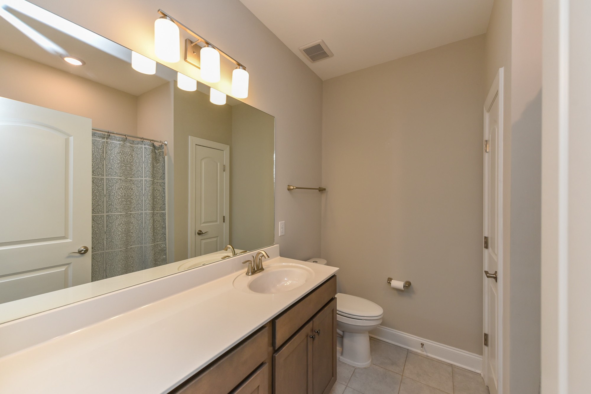 551 Fall Creek Circle Goodlettsville, TN 37072 - Photo 19 of 28 a bathroom with a sink a toilet and mirror