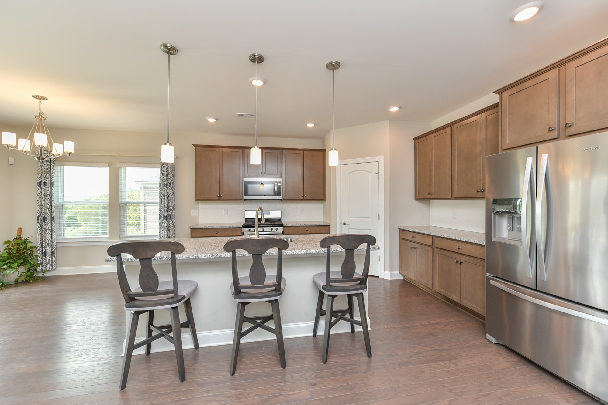 551 Fall Creek Circle Goodlettsville, TN 37072 - Photo 4 of 28 a kitchen with stainless steel appliances granite countertop a stove a refrigerator a kitchen island with a stove and white cabinets