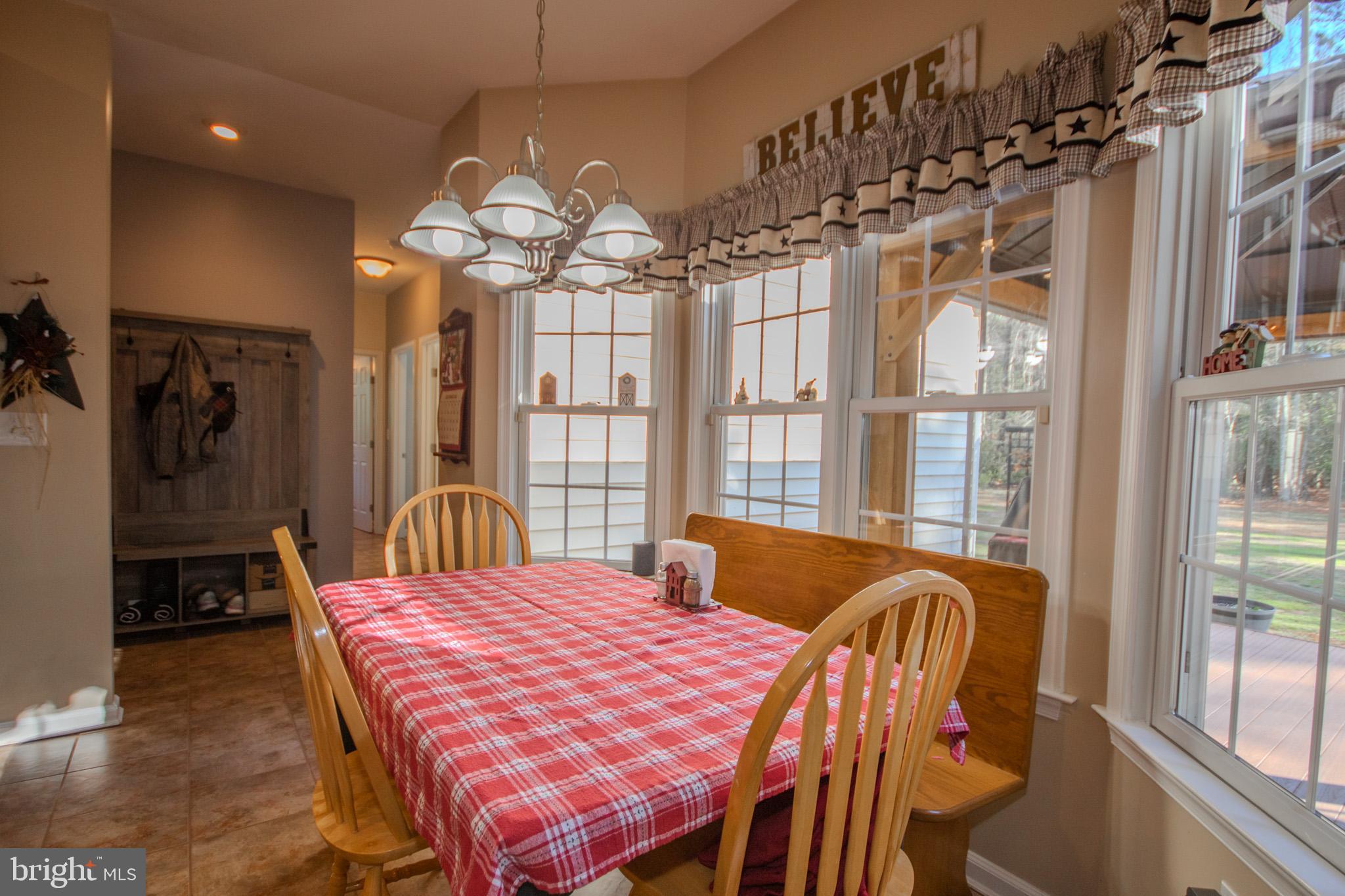 7395 Cherry Walk Road Hebron, MD 21830 - Photo 18 of 61 a view of a dining room with furniture a chandelier and wooden floor